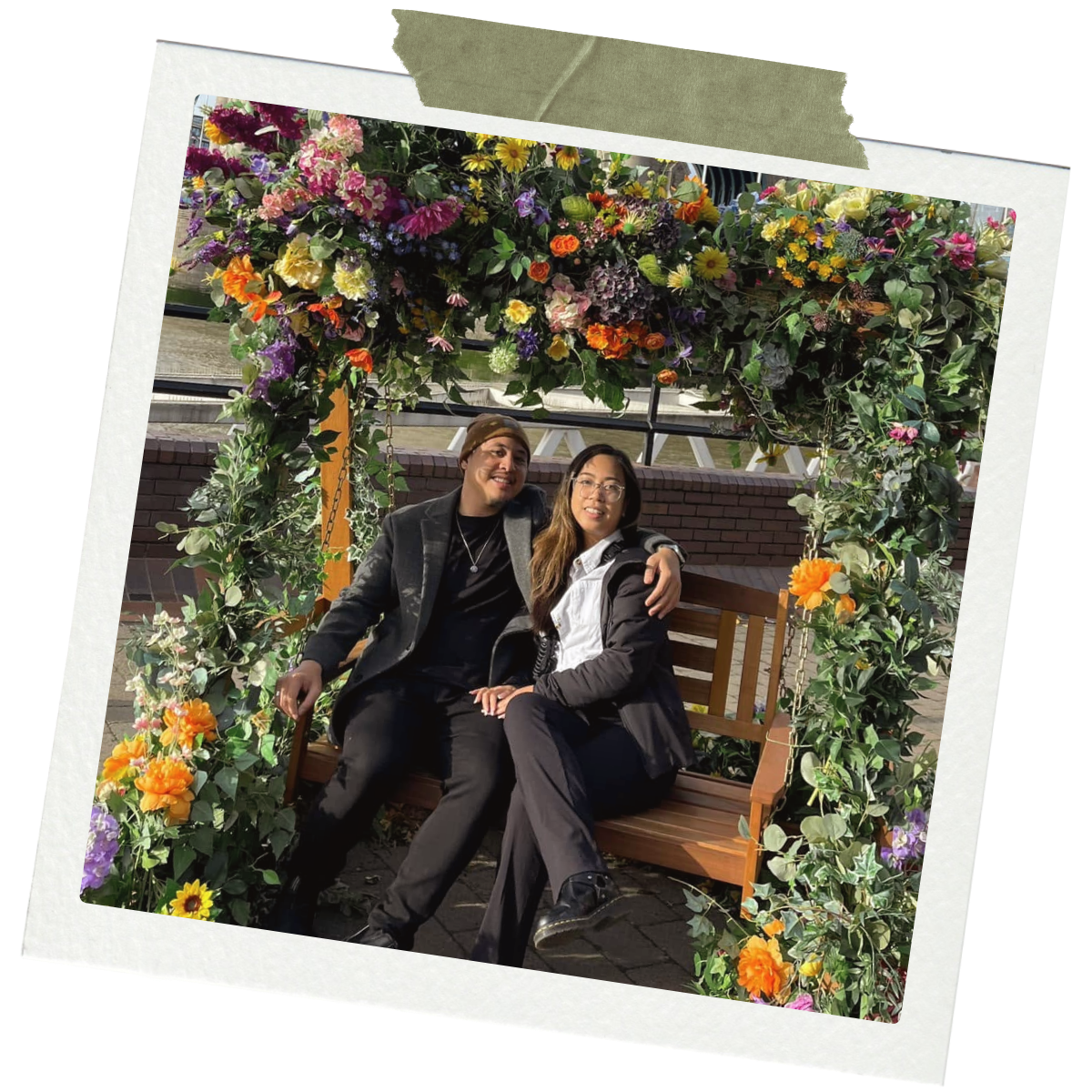 Jyselle and Kyle under a flower arch